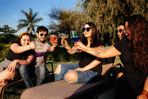 people talking and drinking outside